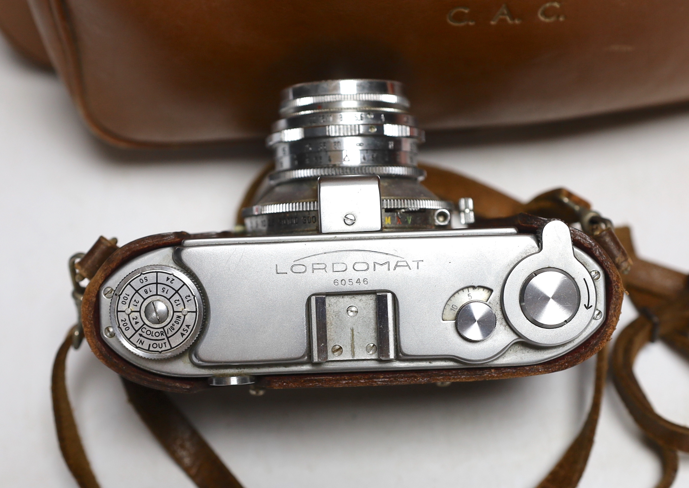 A Lordomat leather cased camera, lenses, flashgun, tripod and larger camera case